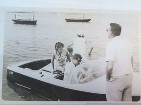In this undated photo provided by Guernsey's, John F. Kennedy is at the wheel of his speedboat, Restofus. Guernsey's auction house says a wide array of the president's memorabilia will be offered on Oct. 6-7, 2017. (Guernsey's via AP)