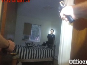CORRECTS DATE TO 6TH, NOT 7TH- In this Sept. 6, 2017, image taken from a New York Police Department officer's body camera video, officers aim their weapons towards Miguel Richards as Richards kneels on his bed in his New York apartment while holding a knife. The officers shot and killed Richards after he pointed a gun at them that turned out to be fake. Release of the body cam video marked the first fatal police encounter captured on the devices since officers started wearing them this year. (New York Police Department via AP)