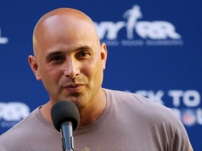 FILE - In this Aug. 30, 2012, file photo, Craig Carton talks during the National Football League Back to Football Run at Central Park in New York. Federal officials said the New York sports radio host is in custody and details of the charges against the host of WFAN-AM's "Boomer and Carton" show were not immediately made public Wednesday, Sept. 6, 2017. (John Minchillo/AP Images for NFL, File)