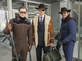 FILE - This file image released by Twentieth Century Fox shows, from left, Taron Egerton, Colin Firth, and Pedro Pascal in "Kingsman: The Golden Circle." The R-rated spy comedy "Kingsman: The Golden Circle" has taken over the top spot at the North American box office with an estimated $39 million debut. The 20th Century Fox release pushed the Stephen King sensation "It" into second place in its third week of release.(Giles Keyte/Twentieth Century Fox via AP, File)