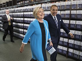 Hillary Rodham Clinton, escorted by Leonard Riggio, chairman of Barnes and Noble, arrives to sign copies of her book "What Happened" at a book store in New York, Tuesday, Sept. 12, 2017. (AP Photo/Seth Wenig)