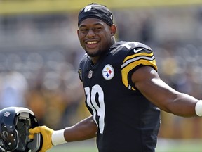 FILE - In this Sunday, Sept. 17, 2017, file photo, Pittsburgh Steelers wide receiver JuJu Smith-Schuster warms up before an NFL football game in Pittsburgh. The youngest player in the NFL wears SpongeBob slippers and scored the first touchdown of his career last weekend, though 20-year-old Steelers wide receiver JuJu Smith-Schuster may have turned more heads with a crunching block that showed the NFL is child's play. (AP Photo/Don Wright, File)