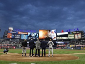 Baltimore Orioles manager Buck Showalter, left, Paul O'Neill, second from left, Willie Randolph, David Cone and New York Yankees manager Joe Girardi pay their respects during a moment of silence for Gene "Stick" Michael before a baseball game between the Yankees and the Orioles, Friday, Sept. 15, 2017, in New York. (AP Photo/Frank Franklin II)