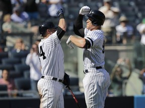 New York Yankees' Aaron Judge, right, celebrates his two-run homer with Gary Sanchez during the third inning of a baseball game against the Kansas City Royals at Yankee Stadium, Monday, Sept. 25, 2017, in New York. It was Judge's 49th home run, which ties the MLB rookie home run record. (AP Photo/Seth Wenig)