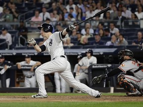 New York Yankees' Todd Frazier follows through on a three-run home run during the first inning of a baseball game against the Baltimore Orioles on Thursday, Sept. 14, 2017, in New York. (AP Photo/Frank Franklin II)