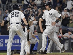 New York Yankees' Gary Sanchez, right, celebrates with Jacoby Ellsbury (22) and Brett Gardner after they all scored on a double by Starlin Castro during the sixth inning of a baseball game against the Boston Red Sox, Sunday, Sept. 3, 2017, at Yankee Stadium in New York. (AP Photo/Bill Kostroun)