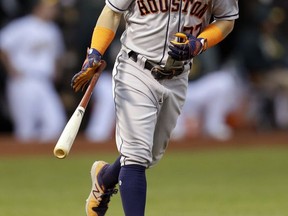 Houston Astros' Jose Altuve drops his bat after hitting a two-run home run off Oakland Athletics' Jharel Cotton in the first inning of a baseball game Friday, Sept. 8, 2017, in Oakland, Calif. (AP Photo/Ben Margot)
