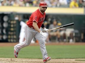 Los Angeles Angels' Albert Pujols runs to first base after hitting an RBI single against the Oakland Athletics in the fourth inning of a baseball game, Monday, Sept. 4, 2017, in Oakland, Calif. (AP Photo/Ben Margot)