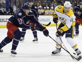 Nashville Predators' Kevin Fiala, right, of Switzerland, tries to shoot the puck past Columbus Blue Jackets' Ryan Collins during the first period of an NHL preseason hockey game Sunday, Sept. 24, 2017, in Columbus, Ohio. (AP Photo/Jay LaPrete)