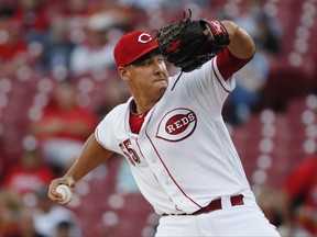 Cincinnati Reds starting pitcher Robert Stephenson winds up during the first inning of a baseball game against the Milwaukee Brewers, Tuesday, Sept. 5, 2017, in Cincinnati. (AP Photo/John Minchillo)
