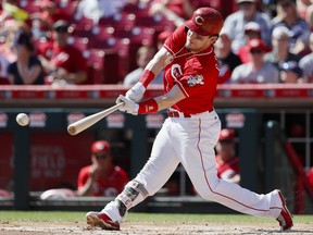 Cincinnati Reds' Scooter Gennett hits an RBI double off Boston Red Sox starting pitcher Doug Fister in the first inning of a baseball game, Sunday, Sept. 24, 2017, in Cincinnati. (AP Photo/John Minchillo)