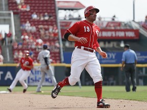 Cincinnati Reds' Joey Votto runs to third on a single by Scooter Gennett off Milwaukee Brewers starting pitcher Chase Anderson in the sixth inning of a baseball game, Monday, Sept. 4, 2017, in Cincinnati. (AP Photo/John Minchillo)