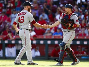 Boston Red Sox relief pitcher Craig Kimbrel (46) celebrates with catcher Christian Vazquez, right, after recording a save and closing the ninth inning of a baseball game, Sunday, Sept. 24, 2017, in Cincinnati. The Red Sox won 5-4. (AP Photo/John Minchillo)