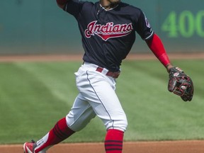 Cleveland Indians' Francisco Lindor throws out Kansas City Royals' Whit Merrifield at first base during the first inning of a baseball game in Cleveland, Sunday, Sept. 17, 2017. (AP Photo/Phil Long)