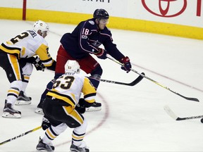 Columbus Blue Jackets forward Pierre-Luc Dubois, right, shoots the puck against Pittsburgh Penguins defenseman Chad Ruhwedel, left, and forward Theodor Blueger, of Latavia, during the third period of a preseason NHL hockey game in Columbus, Ohio, Friday, Sept. 22, 2017. Dubois scored on the play. The Penguins won 4-3. (AP Photo/Paul Vernon)