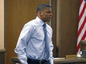 FILE – In this March 17, 2013, file photo, Ma'Lik Richmond walks toward the victim and her family to apologize after he and co-defendant Trent Mays were found delinquent on rape and other charges during their trial in juvenile court in Steubenville, Ohio. Richmond sued Youngstown State University in federal court Wednesday, Sept. 13, 2017, after the school allowed him to join the football team but then told him he couldn't play this season, after a female student circulated a petition asking that Richmond be kept off the team. (AP Photo/Keith Srakocic, Pool, File)