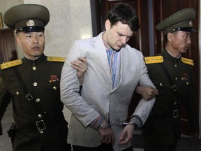 American student Otto Warmbier, center, is escorted at the Supreme Court in Pyongyang, North Korea on March 16, 2016.