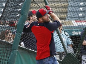 UFC heavyweight champion Stipe Miocic takes batting practice with the Cleveland Indians before a baseball game against the Detroit Tigers, Monday, Sept. 11, 2017, in Cleveland. (AP Photo/Ron Schwane)