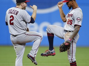 Minnesota Twins' Brian Dozier (2) and Byron Buxton (25) celebrate an 8-6 victory over the Cleveland Indians in a baseball game, Tuesday, Sept. 26, 2017, in Cleveland. (AP Photo/Ron Schwane)