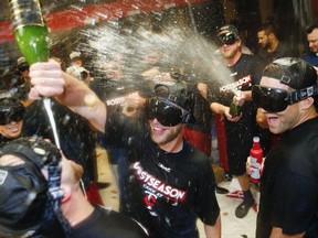 The Minnesota Twins celebrate early Thursday, Sept. 28, 2017, in Cleveland. The Twins earned an AL wild-card berth after the Los Angeles Angels lost to the Chicago White Sox. The Twins had lost 4-2 to the Cleveland Indians on Wednesday night. (AP Photo/Ron Schwane)