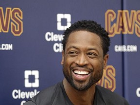 Cleveland Cavaliers' Dwyane Wade smiles as he answers questions during a news conference at the NBA basketball team's training facility, Friday, Sept. 29, 2017, in Independence, Ohio. Wade once convinced LeBron James that Miami was the place to be. Seven years later, James lured Wade to Ohio for the chance to win another NBA title, together. (AP Photo/Tony Dejak)