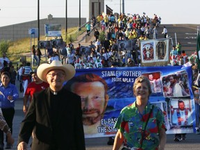 Faithful walk in a pilgrimage from St. James the Greater Catholic Church to attend the beatification ceremony for the Rev. Stanley Rother, at the Cox Convention Center in downtown Oklahoma City,  Saturday, Sept. 23, 2017. (Doug Hoke/The Oklahoman via AP)