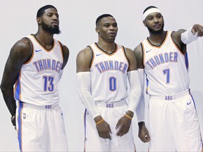 Oklahoma City Thunder's Paul George (13), Russell Westbrook (0) and Carmelo Anthony (7) pose for photos during an NBA basketball media day in Oklahoma City, Monday, Sept. 25, 2017. (AP Photo/Sue Ogrocki)