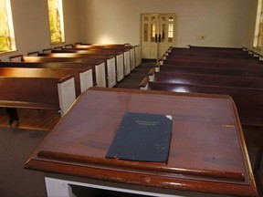 In this Thursday, Sept. 14, 2017 photo, a New Testament and Psalms book is pictured inside the Kathryn P. Boswell Memorial Chapel on the campus of East Central University in Ada, Okla. The small chapel nestled on a university campus in a rural central Oklahoma town is at the center of a public firestorm over the use of religious symbols on public property after a Washington, D.C.-based group insisted that a cross be removed from atop its steeple. (AP Photo/Sue Ogrocki)
