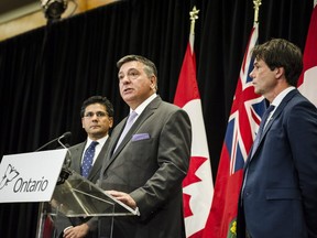Minister of Finance, Charles Sousa, centre, Attorney General, Yasir Naqvi, left, and Minister of Health and Long-Term Care, Eric Hoskins speak during a press conference where they detailed Ontario's solution for recreational marijuana sales, in Toronto on Friday, September 8, 2017.