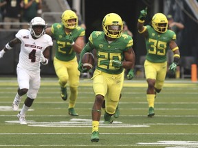 Oregon running back Tony Brooks-James, center, breaks into the open on his way to a touchdown on a kickoff return to start the game against Southern Utah plays in an NCAA college football game Saturday, Sept. 2, 2017, in Eugene, Ore. (AP Photo/Chris Pietsch)