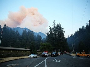 Fire burns in the Eagle Creek area of Columbia River Gorge, Saturday, Sept. 2, 2017. Officials reported that they had rescued six hikers Sunday morning, who were among about 140 forced to spend the night outside near Tunnel Falls after a fire broke out near the popular Columbia River Gorge trail about 90 miles east of Portland. (Mark Graves/The Oregonian via AP)