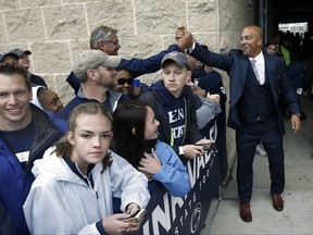 Penn State head coach James Franklin, right, shakes hands with a fan as the team arrives at the stadium to take on Akron in an NCAA college football game in State College, Pa., Saturday, Sept. 2, 2017. (AP Photo/Chris Knight)
