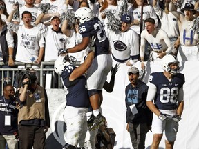 Penn State's Saquon Barkley (26) is lifted in the air by lineman Steven Gonzalez (74) after he scored a touchdown against Pittsburgh during the second half of an NCAA college football game in State College, Pa., Saturday, Sept. 9, 2017. Penn State won 33-14. (AP Photo/Chris Knight)