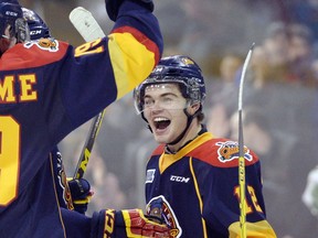 FILE - In this Jan. 31, 2016, file photo, Erie Otters right wing Alex DeBrincat celebrates with teammates after scoring against the Mississauga Steelheads during the third period of their OHL hockey game at Erie Insurance in Erie, Pa. DeBrincat piled up huge numbers with the Erie Otters of the Ontario Hockey League last season. Now one of the NHL's top prospects is getting a chance to make the Chicago Blackhawks.  (Andy Colwell/Erie Times-News via AP, File)