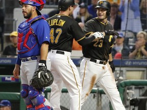 Pittsburgh Pirates' Jordan Luplow (47) celebrates with David Freese (23) behind Chicago Cubs catcher Rene Rivera after hitting a two-run home run off Cubs' Kyle Hendricks during the second inning of a baseball game in Pittsburgh, Tuesday, Sept. 5, 2017. (AP Photo/Gene J. Puskar)