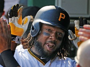 Pittsburgh Pirates' Josh Bell celebrates in the dugout after hitting a two-run home run off Chicago Cubs starting pitcher Jake Arrieta in the first inning of a baseball game in Pittsburgh, Monday, Sept. 4, 2017. (AP Photo/Gene J. Puskar)