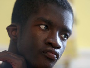 In this July 28, 2017, file photo, Jared, 20, a disabled adopted son of Vivian Shine-King, watches television at his home in Philadelphia. For foster parents of disabled children, money is getting tighter. The reimbursements are seen as crucial because the high costs of caring for such children makes it less likely they'll ever be adopted. Philadelphia, Missouri and Oklahoma are among places giving payments to foster parents of disabled children a closer look. (AP Photo/Jacqueline Larma)