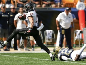 Oklahoma State wide receiver Dillon Stoner (17) breaks away from Pittsburgh defensive back Dennis Briggs (20) after making a catch to run it in for a touchdown in the first quarter of an NCAA college football game, Saturday, Sept. 16, 2017, in Pittsburgh. (AP Photo/Keith Srakocic)