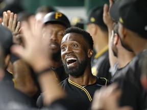 Pittsburgh Pirates' Andrew McCutchen celebrates his first career grand-slam home run in the dugout with teammates in the second inning of the baseball game against the Baltimore Orioles on Tuesday, Sept. 26, 2017, in Pittsburgh. (AP Photo/Keith Srakocic)