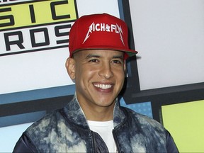 FILE - In this Oct. 8, 2015, file photo, Daddy Yankee poses backstage at the Latin American Music Awards in Los Angeles. On Sept. 28, 2017, Daddy Yankee pledged $1 million to Hurricane Maria relief in his native Puerto Rico. (Photo by Paul A. Hebert/Invision/AP, File)