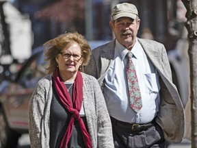 FILE – In this March 9, 2017, file photo, Deborah Frein, left, and Eugene Michael Frein, right, the parents of Eric Frein, walk to the Chester County Justice Center in West Chester, Pa. The widow of a Pennsylvania state trooper fatally shot by Eric Frein filed a wrongful death lawsuit Thursday, Sept. 21, 2017, against Frein's parents, after Eric Frein was convicted of murder and sentenced to death in April. The lawsuit alleges Frein's parents psychologically manipulated their son "into developing a strong dislike for police and acting on that dislike." (AP Photo/Matt Rourke, File)