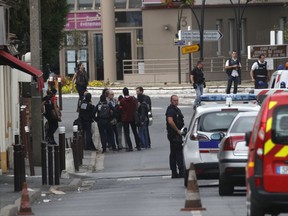 French police officers stand outside a building in Villejuif, south of Paris, Wednesday, Sept. 6, 2017 in Paris. The Paris prosecutor's office says two people have been detained after a possible explosives laboratory was discovered in a suburb south of Paris. (AP Photo/Christophe Ena)