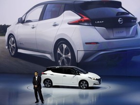 FILE - In this Wednesday, Sept. 6, 2017 file photo, Nissan President and CEO Hiroto Saikawa unveils its new Leaf electric vehicle during the world premiere in Chiba, Japan. The Renault-Nissan alliance is ramping up electric car production, vowing 12 new models by 2022 and to make electric cars 30 percent of its overall production. (AP Photo/Eugene Hoshiko, File)