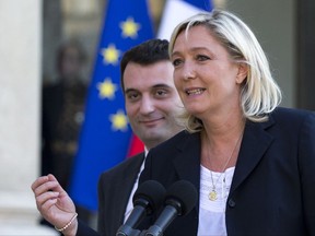 FILE- In this May 16, 2014 file photo, French far-right Front National Party President Marine Le Pen and vice-president Florian Philippot, left, talk to the media at the Elysee Palace, in Paris, France. The right-hand man of French far-right leader Marine Le Pen, Florian Philippot, has quit the National Front in a power dual stemming from May's bruising election defeat. (AP Photo/Jacques Brinon, File)