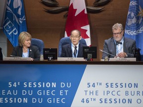Chair Hoesung Lee addresses the opening session of the Intergovernmental Panel on Climate Change next to Martine Dubuc, Canadian Associate Deputy Minister of Environment and Climate Change, Wednesday, and David Grimes, chair of the World Meteorological Organisation, September 6, 2017 in Montreal. THE CANADIAN PRESS/Paul Chiasson