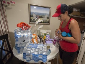 Canadian Audrey Foy gets foods supplies ready for her family at her home in Hollywood, Fla., in preparation for the coming of hurricane Irma Friday, September 8, 2017. THE CANADIAN PRESS/Paul Chiasson