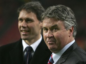 In this Wednesday Feb. 7, 2007, file photo Russia's coach Guus Hiddink of Netherlands, right, and Netherlands' coach Marco van Basten, left, wait for the start of their friendly international soccer match in ArenA stadium in Amsterdam. Guus Hiddink says he is willing to become a technical advisor to South Korea's football team at the World Cup next year, but has dismissed rumors that he will again be appointed coach of the team during a press conference in Amsterdam Thursday Sept. 14, 2017. Hiddink has been revered in South Korea ever since he led the team to the semifinals of the World Cup in 2002 when Korea and Japan co-hosted the tournament. (AP Photo/Peter Dejong)