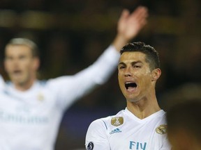 Real Madrid's Cristiano Ronaldo, right, and Real Madrid's Gareth Bale, rear, gesture during a Champions League Group H soccer match between Borussia Dortmund and Real Madrid at the BVB stadium in Dortmund, Germany, Tuesday, Sept. 26, 2017. (AP Photo/Michael Probst)