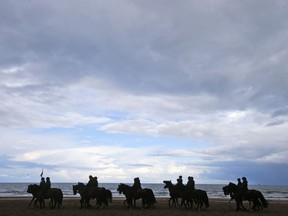 Horses and riders arrive for a practice session for members of the Dutch cavalry in Scheveningen, Netherlands, Monday, Sept. 18, 2017. Horses and riders were rehearsing on a beach in the coastal resort of Scheveningen, outside The Hague, for ceremonies which will be held Tuesday to mark the opening of parliament and the presentation of the caretaker government's budget plans for the year ahead. (AP Photo/Peter Dejong)
