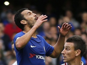 Chelsea's Pedro reacts after missing a chance to score during the English Premier League soccer match between Chelsea and Arsenal at Stamford Bridge stadium in London, Sunday, Sept. 17, 2017. (AP Photo/Frank Augstein)